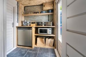 a kitchen with a counter with a microwave at The High Longtail Lodge - Ridgestone in Bowness-on-Windermere +16 photos