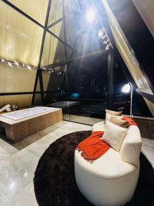 a bathroom with a tub and a couch and a bath tub at Chalés Alto Caparaó in Caparaó Velho +13 photos