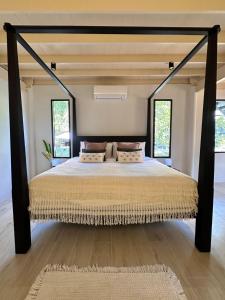 a bedroom with a bed with a black bed frame at Bearwolf Koh Kood in Ko Kood
