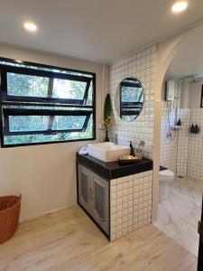 a bathroom with a sink and a toilet at Bearwolf Koh Kood in Ko Kood