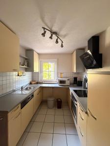 a kitchen with a sink and a counter top at Gemütliche 3-Zimmer-Wohnung mit Kupfertalblick in Forchtenberg