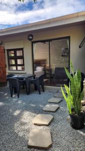 a patio with a ping pong table and a table sidx sidx sidx at Ikaya Accommodation PSJ in Port St. Johns