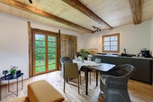 a kitchen and dining room with a table and chairs at Hofgut Heiligenberg in Heiligenberg