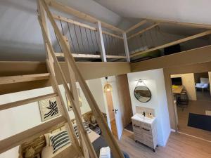 a room with a loft bed and a desk at House in forest proche GR and circuit in Saint-Mars-la-Brière