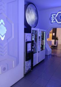 an atm machine in a room with a moon on the wall at CAPSULE INN VALENCIA Hostel in Valencia