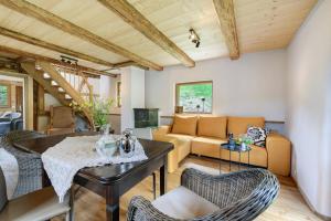 a living room with a couch and a table at Hofgut Heiligenberg in Heiligenberg