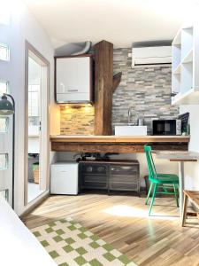 a kitchen with a table and a green chair at The LOFT Apartments Ljubljana in Ljubljana