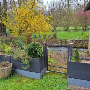a garden with a gate with plants in it at La maison de preuillé in Payré