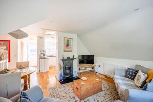a living room with a couch and a fireplace at Comfortable Cottage with Decking in Castle Cary in Castle Cary