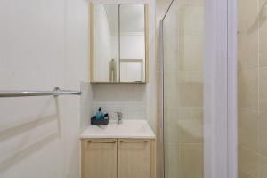 a bathroom with a sink and a shower at Spacious Studio Fourways Sandton - Self Check-in in Sandton +15 photos