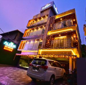 a building with a car parked in front of it at Aleida Residency in Cochin