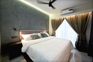 a bedroom with a large white bed and a window at Aleida Residency in Cochin