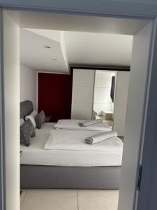 a bedroom with a large bed with a mirror at Premium Apartment near Cologne in Hürth