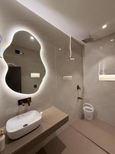 a white bathroom with a sink and a mirror at Kshitij 5 bros in Vasai