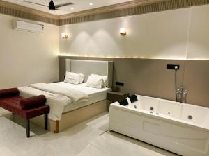 a bedroom with a bed and a bath tub at Kshitij 5 bros in Vasai