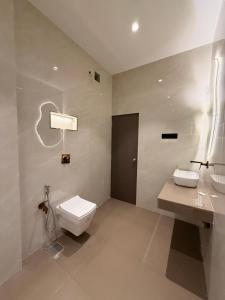 a white bathroom with a toilet and a sink at Kshitij 5 bros in Vasai