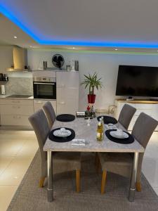 a dining room table and chairs in a kitchen at Premium Apartment near Cologne in Hürth