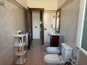 a bathroom with two toilets and a sink at La casa di Nerone in Acireale +42 photos