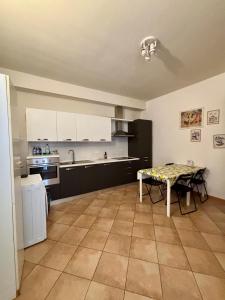 a kitchen with a table in the middle of it at casadiviaappia in Imola