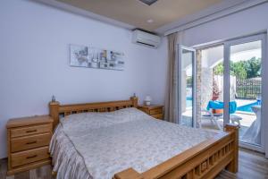 a bedroom with a bed and a sliding glass door at Villa Amalfi in Medulin,Istrien in Medulin +58 photos