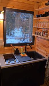 a kitchen with a sink and a window at Star Cottage in Bajina Bašta