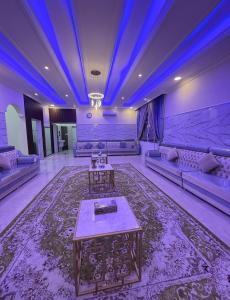 a large living room with couches and a blue ceiling at Hotel Reema Salalah in Salalah