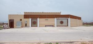 a building with two doors in a parking lot at Hotel Reema Salalah in Salalah