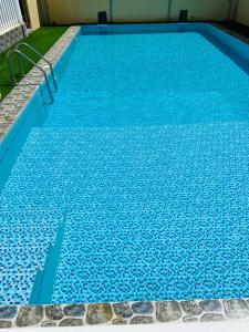 a large blue swimming pool with blue water at Hotel Reema Salalah in Salalah