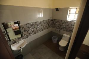 a bathroom with a toilet and a sink at Classique Inn Near Padmanabhaswamy Temple in Trivandrum +25 photos
