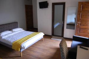 a bedroom with a bed and a sliding glass door at Sky Hotels Emali in Mwanda