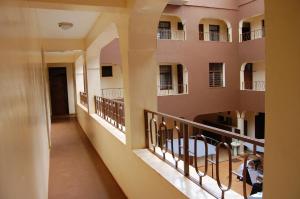 a corridor of an apartment building with balconies at Sky Hotels Emali in Mwanda