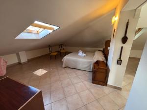a attic room with a bed and a skylight at il SOLE DELL' ALCANTARA in Gaggi