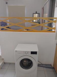 a washing machine in a room with a shelf at Bella Vista renovated in Istro