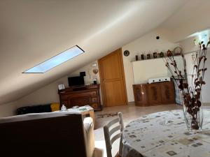 a living room with a table and a window at il SOLE DELL' ALCANTARA in Gaggi