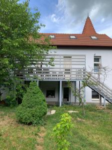 a large white building with a tree in the yard at Villa Esztergom in Esztergom