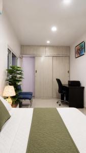 a bedroom with a bed and a desk and a desk at The Onyx by 7 Valleys in Islamabad