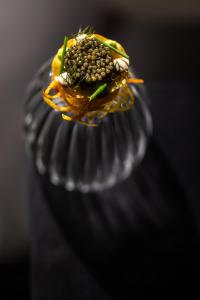 a flower sitting on top of a glass vase at Karels Restaurant Hotel in Braamt