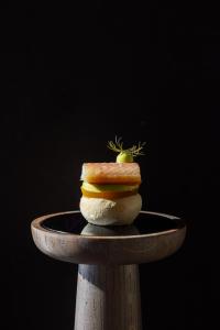 a sandwich sitting on top of a wooden plate at Karels Restaurant Hotel in Braamt