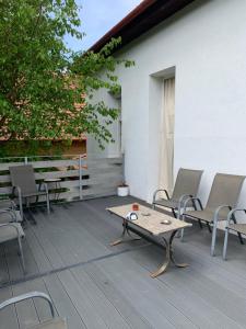 a patio with chairs and a coffee table on a deck at Kempelen kúria in Esztergom