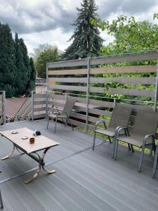 a patio with two chairs and a table on a deck at Kempelen kúria in Esztergom +23 photos