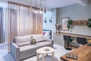 a living room with a couch and a table at Ernest Suites Monastiraki in Athens