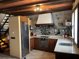 a kitchen with a stainless steel refrigerator and a sink at Casa Rural David in Chía +13 photos