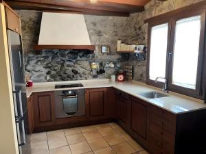 a kitchen with a sink and a stove at Casa Rural David in Chía