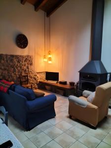 a living room with a couch and a fireplace at Casa Rural David in Chía