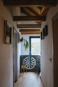 a hallway with a table and a chair in a room at Druhej Domek u ráje in Bystřice