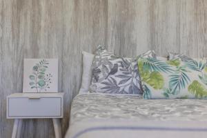 a bedroom with a bed with pillows and a night stand at Casa Muley in El Matorral +18 photos