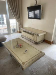 a living room with a coffee table and a flat screen tv at Dolly's Homestay in Galway