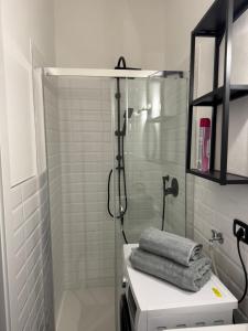 a bathroom with a shower and a sink with towels at Artdeco in Lecco +26 photos