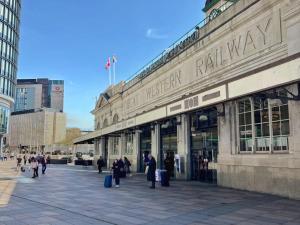 a building with people walking in front of it at Clayton Hotel Cardiff in Cardiff
