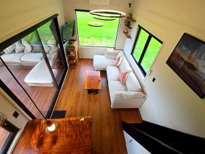 a living room with a white couch and a table at Luxe Tiny Home in Whangarei
